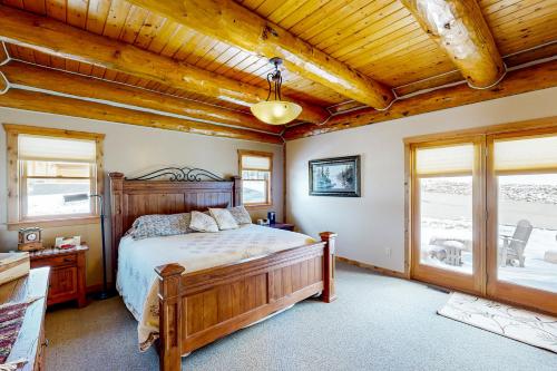 a bedroom with a bed and a wooden ceiling at Cowboy Hollow in Sturgis