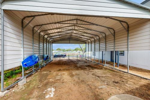 a large metal garage with a dirt road in it at The Blue Laker in Kingsland