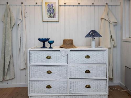 a white dresser with a lamp on top of it at 4 star holiday home in Blokhus-By Traum in Blokhus