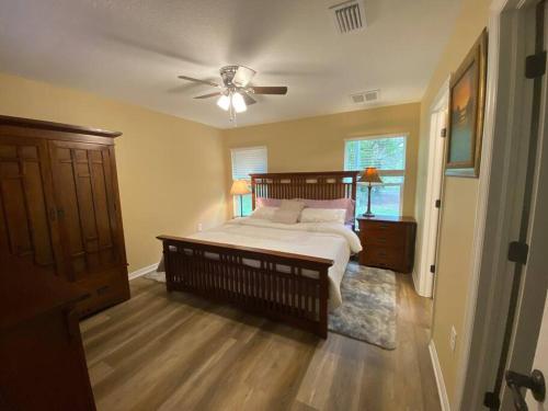 a bedroom with a bed and a ceiling fan at Sundance' Acres *Brand New House*with hot tub in Spring Hill