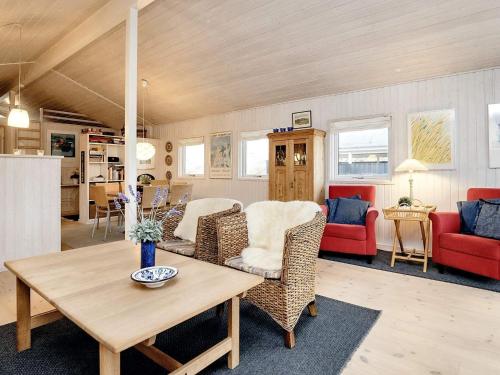 a living room with a table and chairs at 4 star holiday home in Blokhus-By Traum in Blokhus