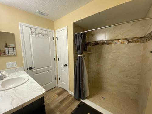 a bathroom with a shower and a sink at Sundance' Acres *Brand New House*with hot tub in Spring Hill