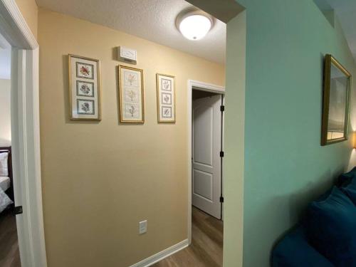 a hallway with a wall with pictures on it at Sundance' Acres *Brand New House*with hot tub in Spring Hill