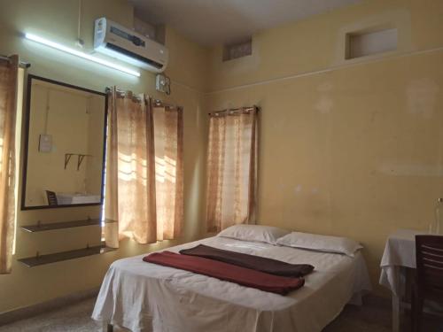 a bedroom with a bed with two towels on it at ORMAYIDAM RESIDENCY in Trivandrum