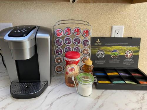 a counter with a coffee maker and a box of donuts at Sundance' Acres *Brand New House*with hot tub in Spring Hill