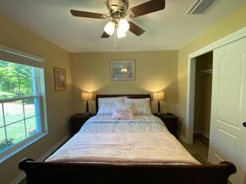 a bedroom with a large bed with a ceiling fan at Sundance' Acres *Brand New House*with hot tub in Spring Hill