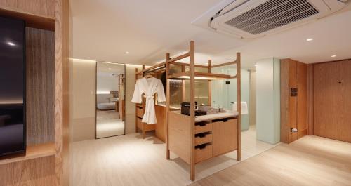 a bathroom with a sink and a mirror at Ad Lib Hotel Bangkok in Bangkok
