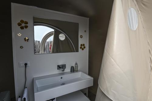 a bathroom with a sink and a mirror at Bubble Room Suite Experience - Bolla Savio Ravenna in Savio di Ravenna
