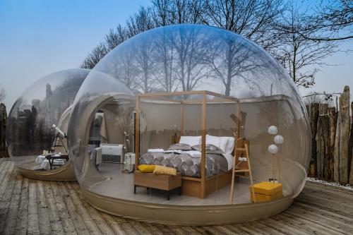 a bed in a glass dome in a bedroom at Bubble Room Suite Experience - Bolla Savio Ravenna in Savio di Ravenna
