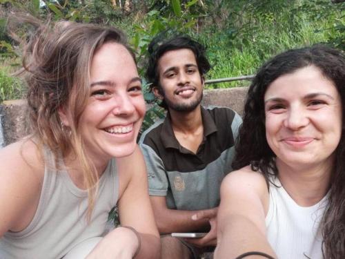 a man and two women sitting next to each other at Mountain View Home stay in Mirigama