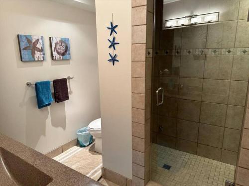 a bathroom with a shower with blue stars on the wall at Verde Vista - Steam Shower - Theatre - Ping-Pong in Fairmont Hot Springs