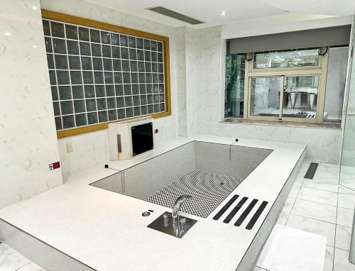 a white kitchen with a sink and a sink at All-Ur Boutique Motel-Jhu Shan Branch in Zhushan