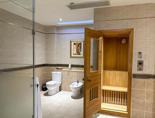 a bathroom with a toilet and a glass door at All-Ur Boutique Motel-Jhu Shan Branch in Zhushan