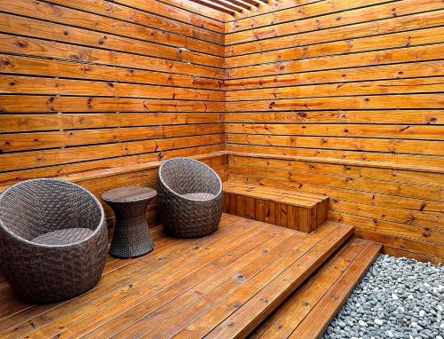 a wooden sauna with three trash cans in it at All-Ur Boutique Motel-Jhu Shan Branch in Zhushan