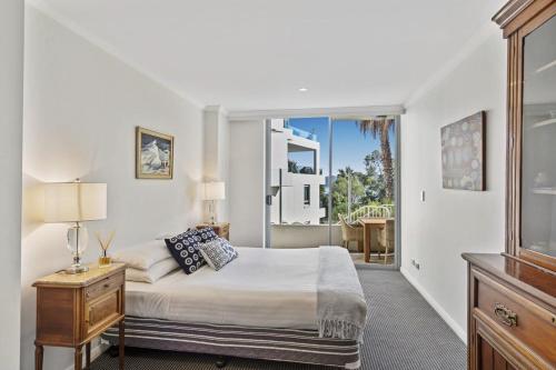 a bedroom with a bed and a large window at Gorgeous 2-Bed Unit near Riverside Parks in Sydney