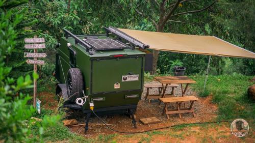 a green grill with a tent and a picnic table at UCM Adventure Park in San Mateo