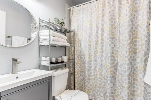 a bathroom with a shower curtain and a sink at Oklahoma Oasis House in Del City