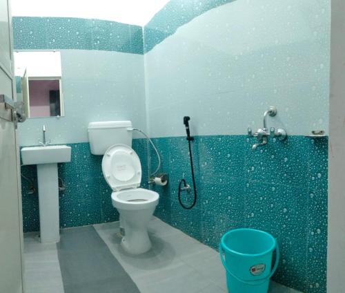 a bathroom with a toilet and a shower at Hotel Royal Grand in Dehradun