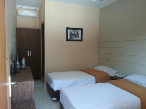 Ένα ή περισσότερα κρεβάτια σε δωμάτιο στο Roemah kita hotel