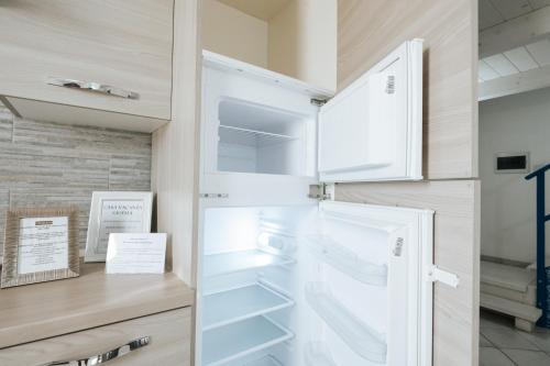 a refrigerator with its door open in a kitchen at Gioema in Borgo Vodice