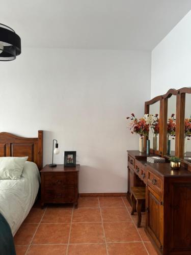 a bedroom with a bed and a desk with flowers on it at Habitacion 801 in Estepona