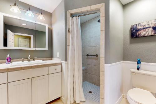 a bathroom with a shower and a toilet and a sink at Riverside Serenity - Unit A in Bradenton