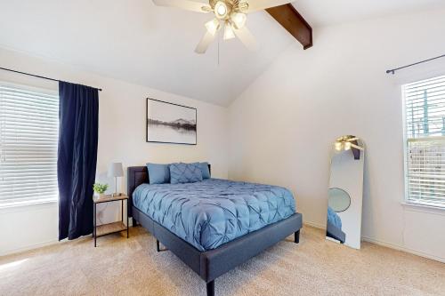 a bedroom with a bed and a ceiling fan at Peachtree in Round Rock