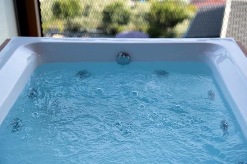 a bath tub filled with blue water in a yard at La Veranda Villas in Kumluca