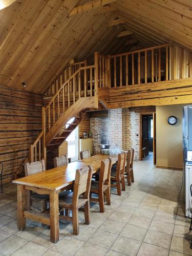 a dining room with a wooden table and chairs at Lainela puhkeküla in Käsmu
