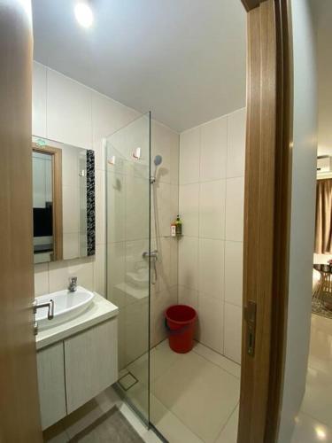 a bathroom with a glass shower and a sink at 2 Bedrooms Baloi Apartment Batam in Nagoya