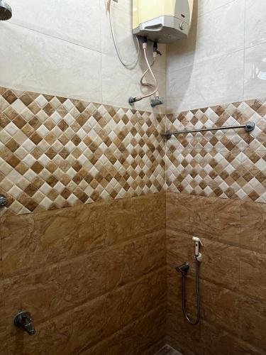 a bathroom with a shower with a shower head at Temple View Home Stay in Tiruvannāmalai