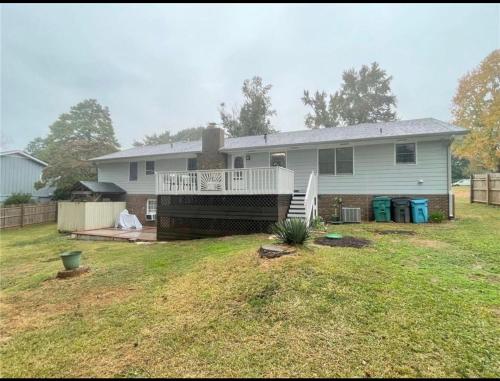 a house with a large yard with a porch at Gorgeous home in Lilburn in Lilburn