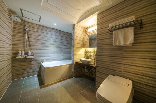 y baño con aseo, bañera y lavamanos. en 호텔 소설스미스( Hotel Soseol Smith) en Cheonan