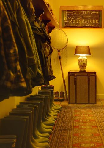 a room with a row of books and a lamp at Ballynahinch Castle Hotel in Ballynahinch