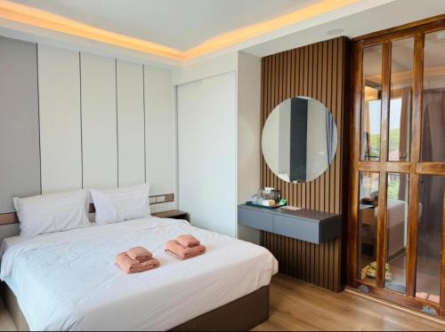 a bedroom with a bed with two towels on it at MAHIDOL CONDO in Chiang Mai