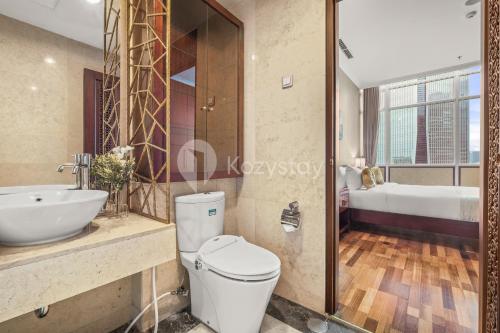 a bathroom with a toilet and a sink at Soka by Kozystay - Mega Kuningan in Jakarta