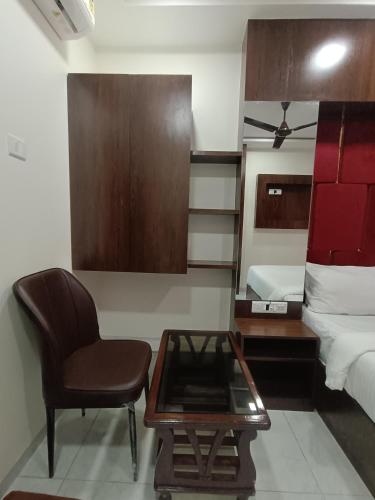 a living room with a chair and a table at AR Residency in Mumbai