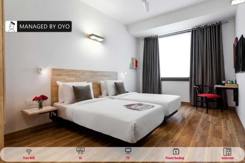 a bedroom with a large white bed and a window at Townhouse Greater Kailash Near Kailash Colony Metro Station in New Delhi