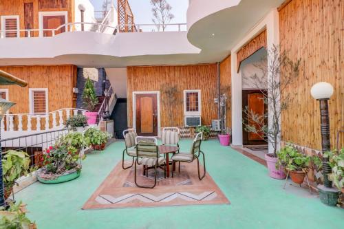 a patio with a table and chairs on it at Hotel O Shanti Kuti Home Stay in Lucknow