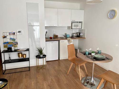 une petite cuisine avec une petite table et une salle à manger dans l'établissement Résidence de Mons en Baroeul, à Mons-en-Baroeul