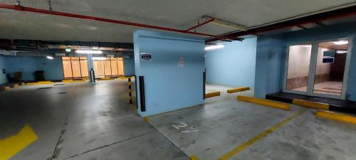 an empty parking garage with a large blue door at HARF4606 Huge water front 1BR Apt with 2 Sofa Beds in Alreem Island in Abu Dhabi