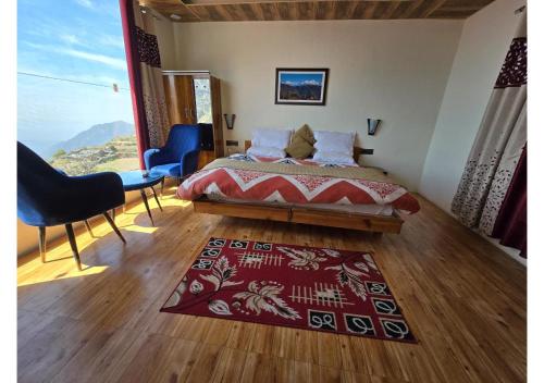 a bedroom with a bed and a red rug at Hill View Retreat in Chakrāta