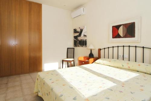 a bedroom with a bed and a wooden cabinet at AIGUESVERDS HomeStay By Turismar in Reus