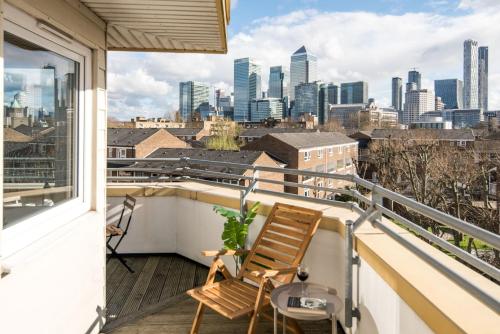 a balcony with a view of the city at CanaryWharf Apartments by Sleepy in London