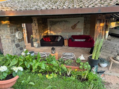 a patio with couches and plants in front of a fireplace at Residenza Ca' degli Enzi in Verona