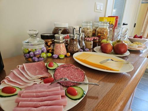 a table topped with plates of meat and fruit at B&B Pippa in Peer