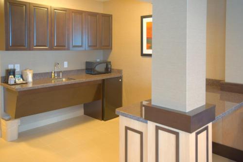 a kitchen with a sink and a counter with a microwave at Holiday Inn Express & Suites Tacoma Downtown, an IHG Hotel in Tacoma