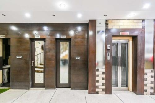 a row of elevators in a building at Hotel Shivdev International in New Delhi