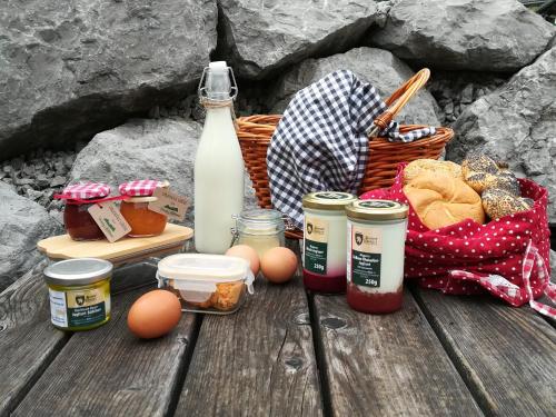 a picnic table with food and a bottle of milk at Ferienhof Mittermair in Vorderstoder