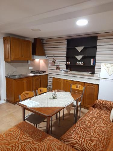 a kitchen with a table and a table and chairs at Villa Markos in Perissa